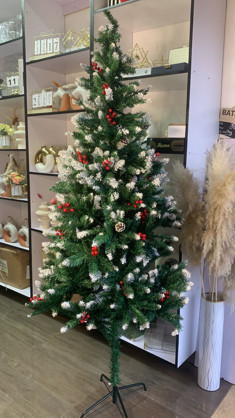 Frosted Christmas tree with cones and berries